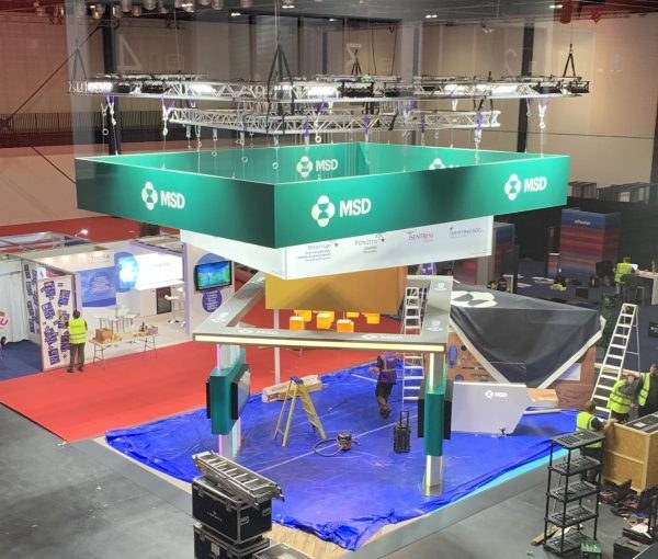 Overhead truss, lighting and suspended branding installed above an exhibition stand